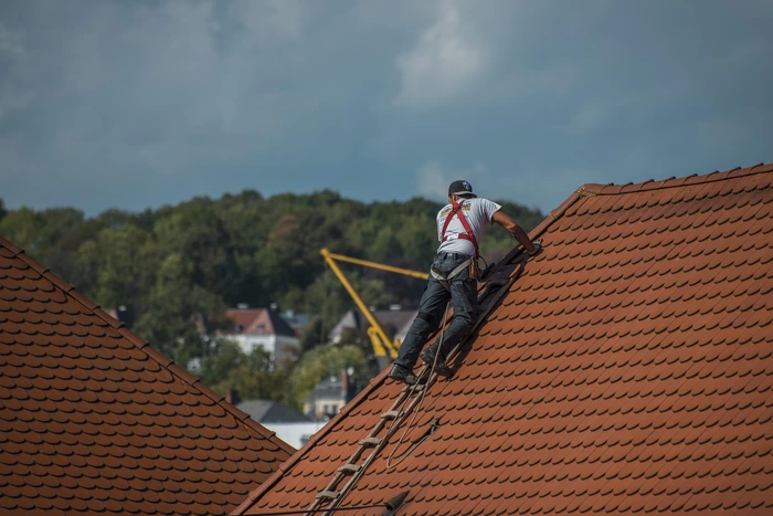 Man on roof in edmonton performing an Emergency Roof Repair